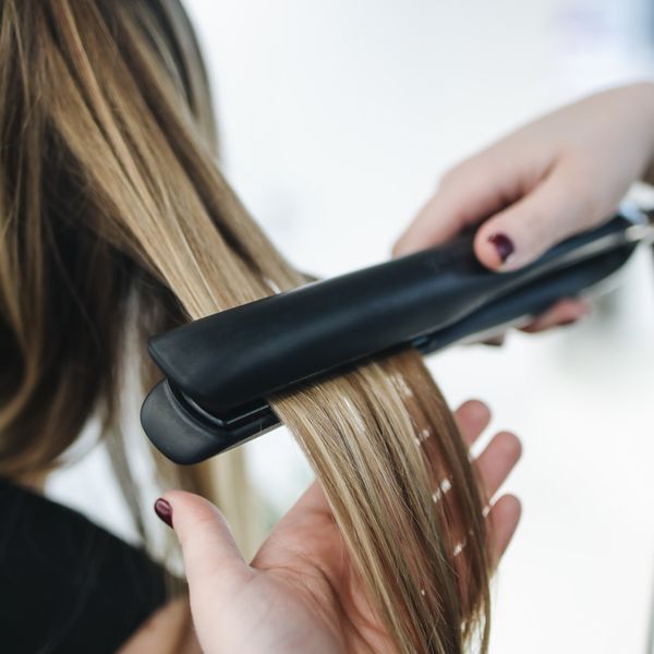 Straightening blonde hair with a flat iron