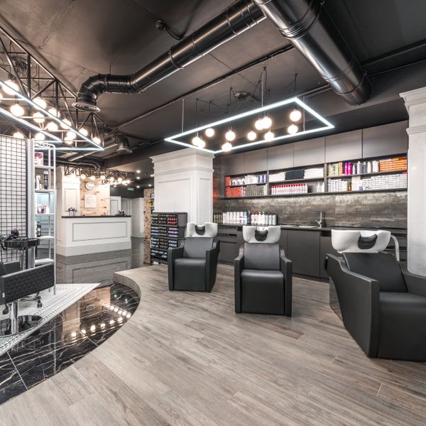 Salon backwash chairs beside a potted plant