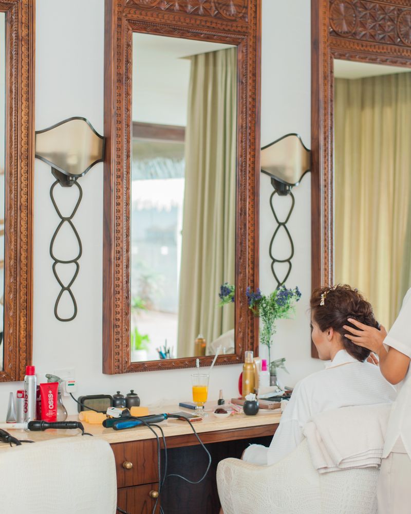 A client seated at a salon mirror during a relaxed consultation